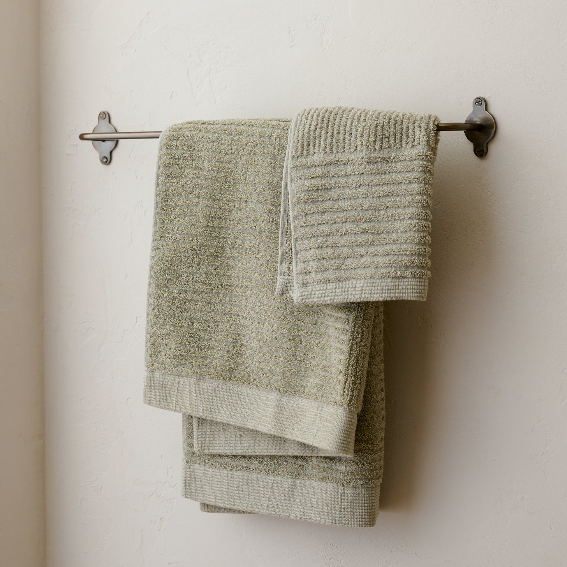 Antique Bronze Metal Towel Bar shown with towels