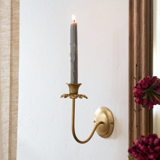 Antique Brass Floral Sconce shown styled with taper candle