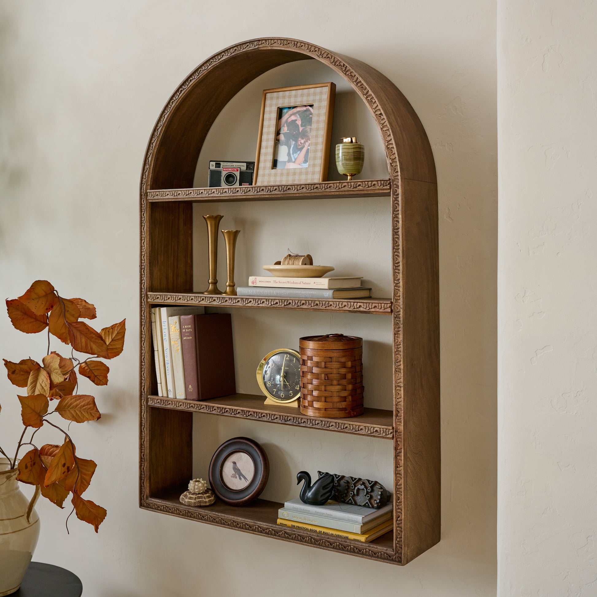 Hand Carved Wooden Archer Shelf shown styled on wall