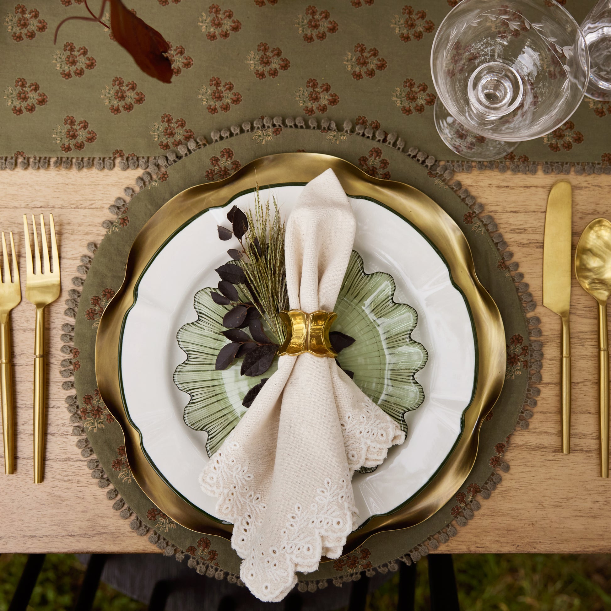 Emmeline Green Scalloped Glass Plate on a place setting
