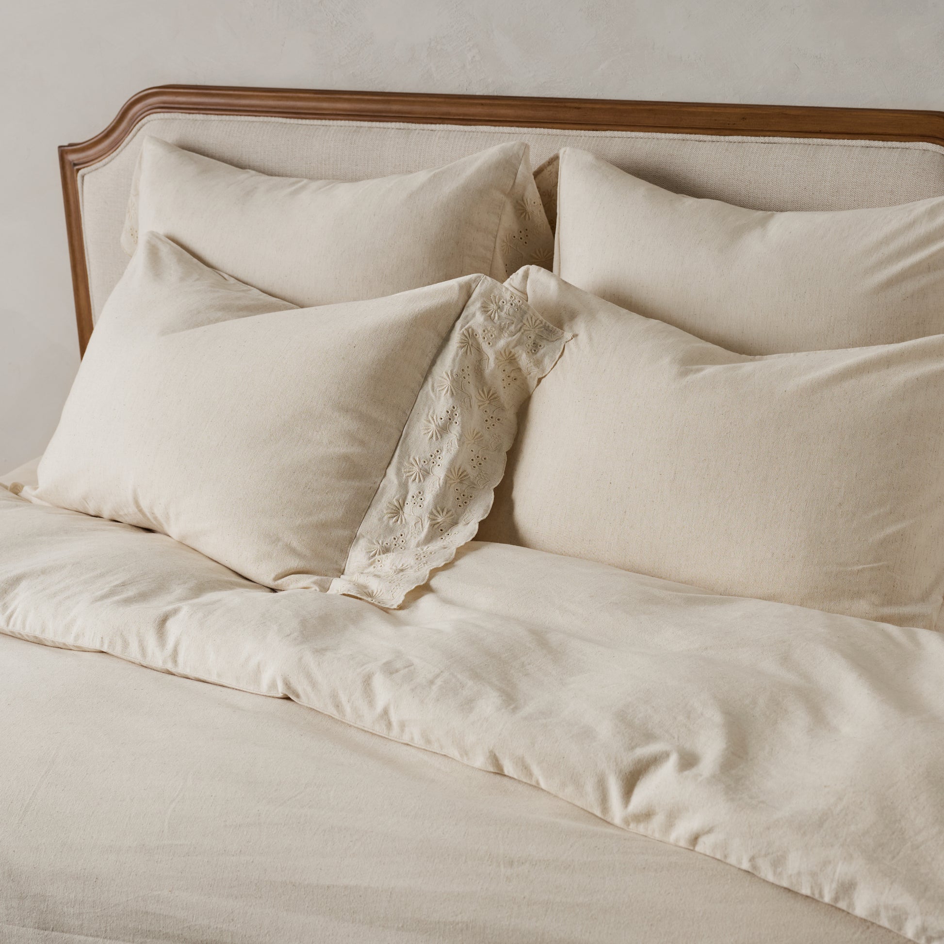 Clara Eyelet Flange Duvet Cover in color Natural shown on bed