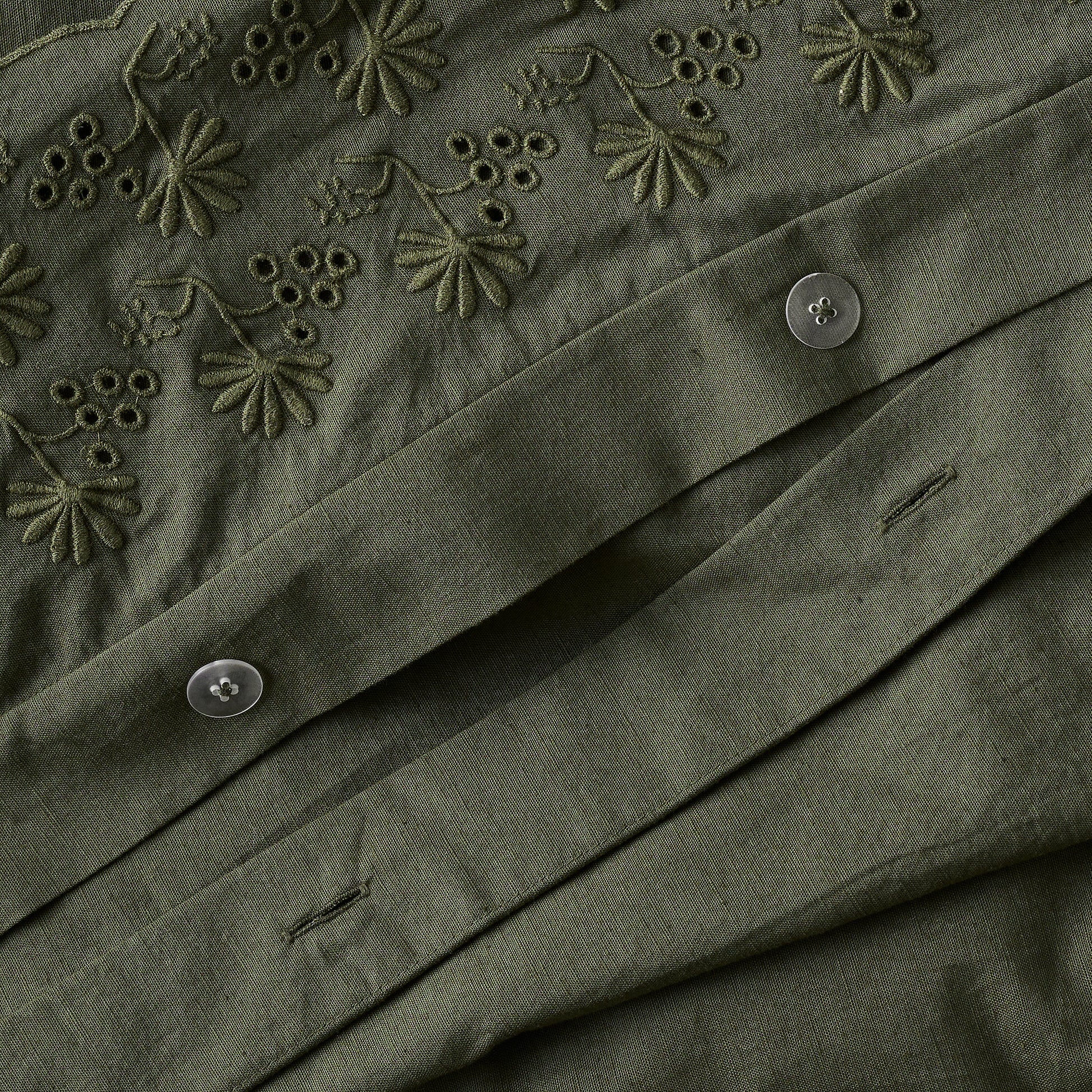 Clara Eyelet Flange Duvet Cover in color Olive Night button closure up close