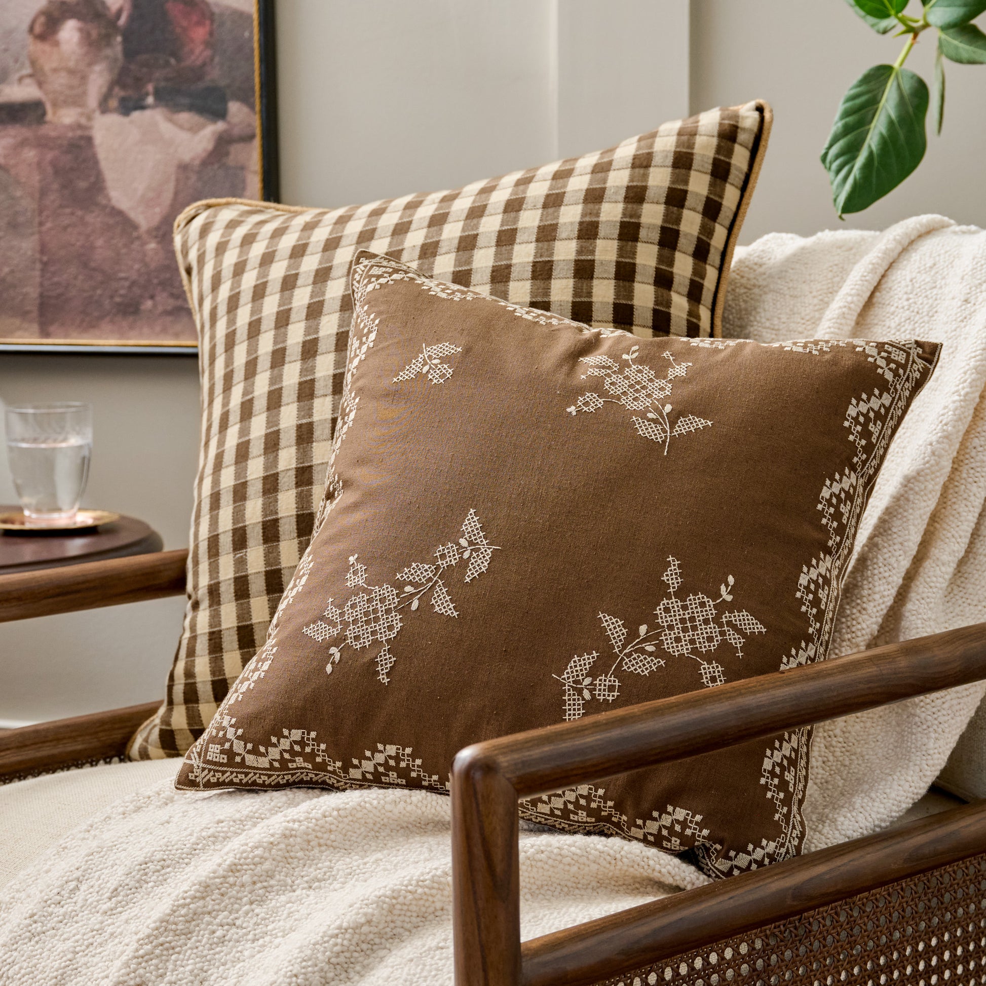 Lacey Embroidered Throw Pillow shown on chair