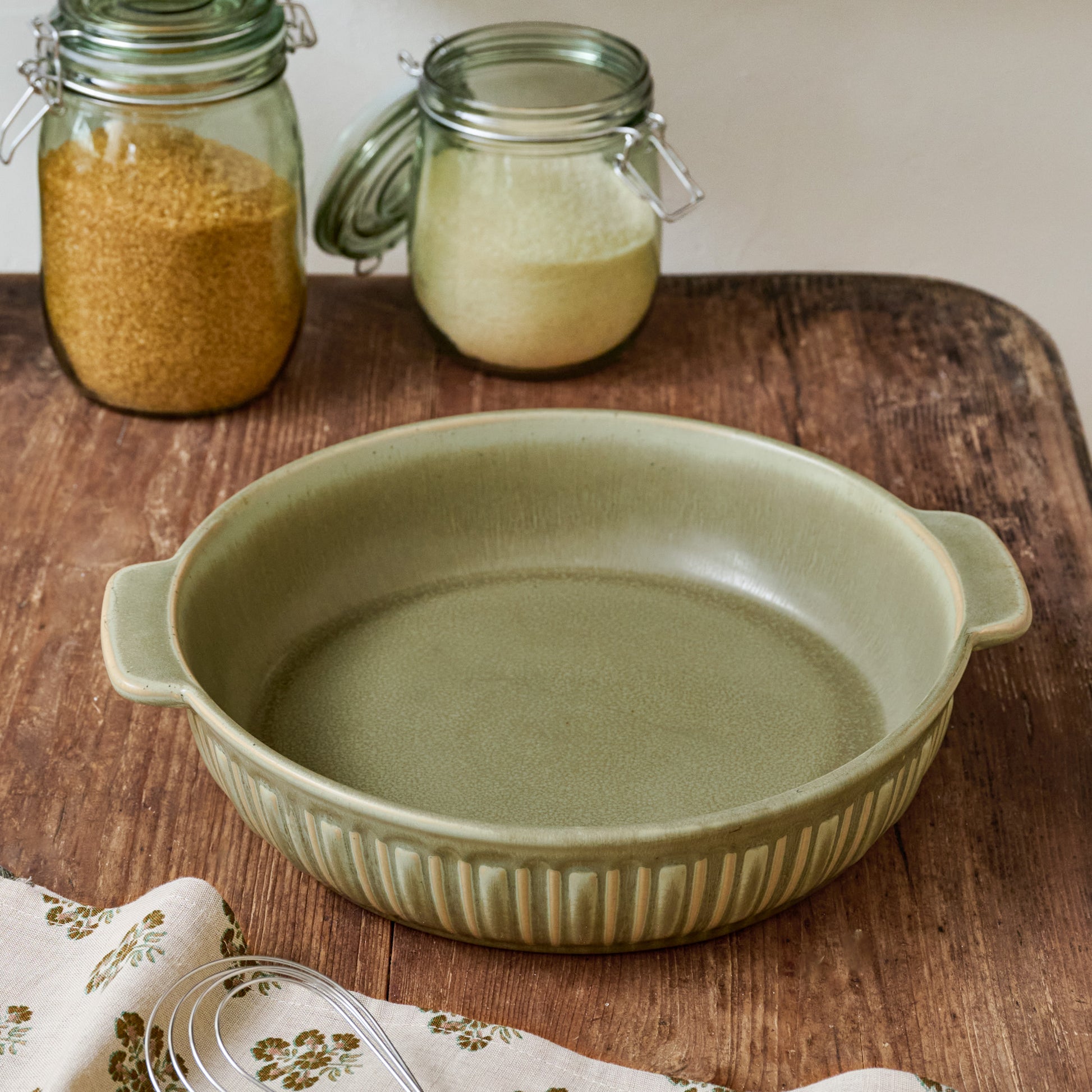 The Cottage Collection Laurel Green Round Baking Dish shown on table