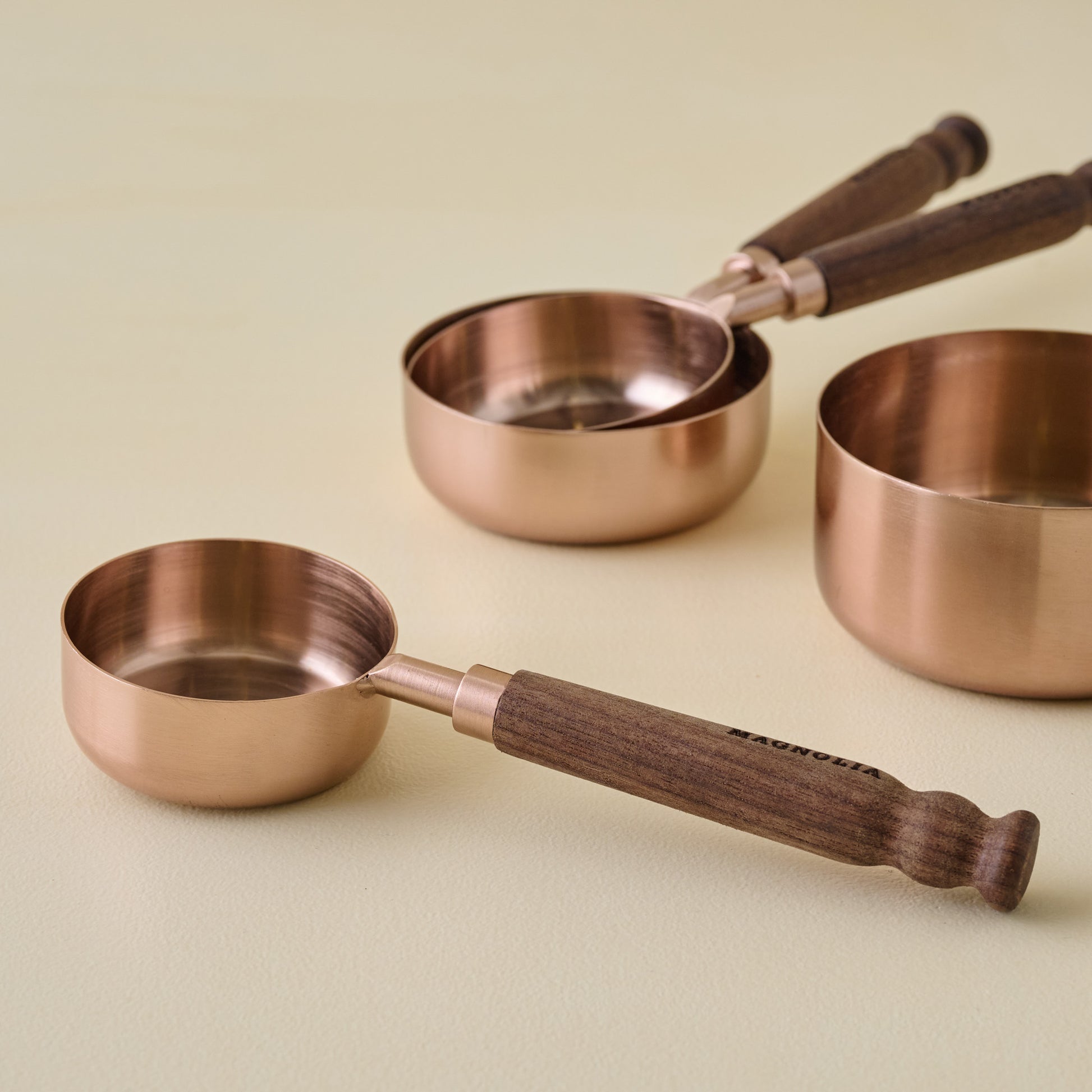 Walnut + Copper Measuring Cups separated close up