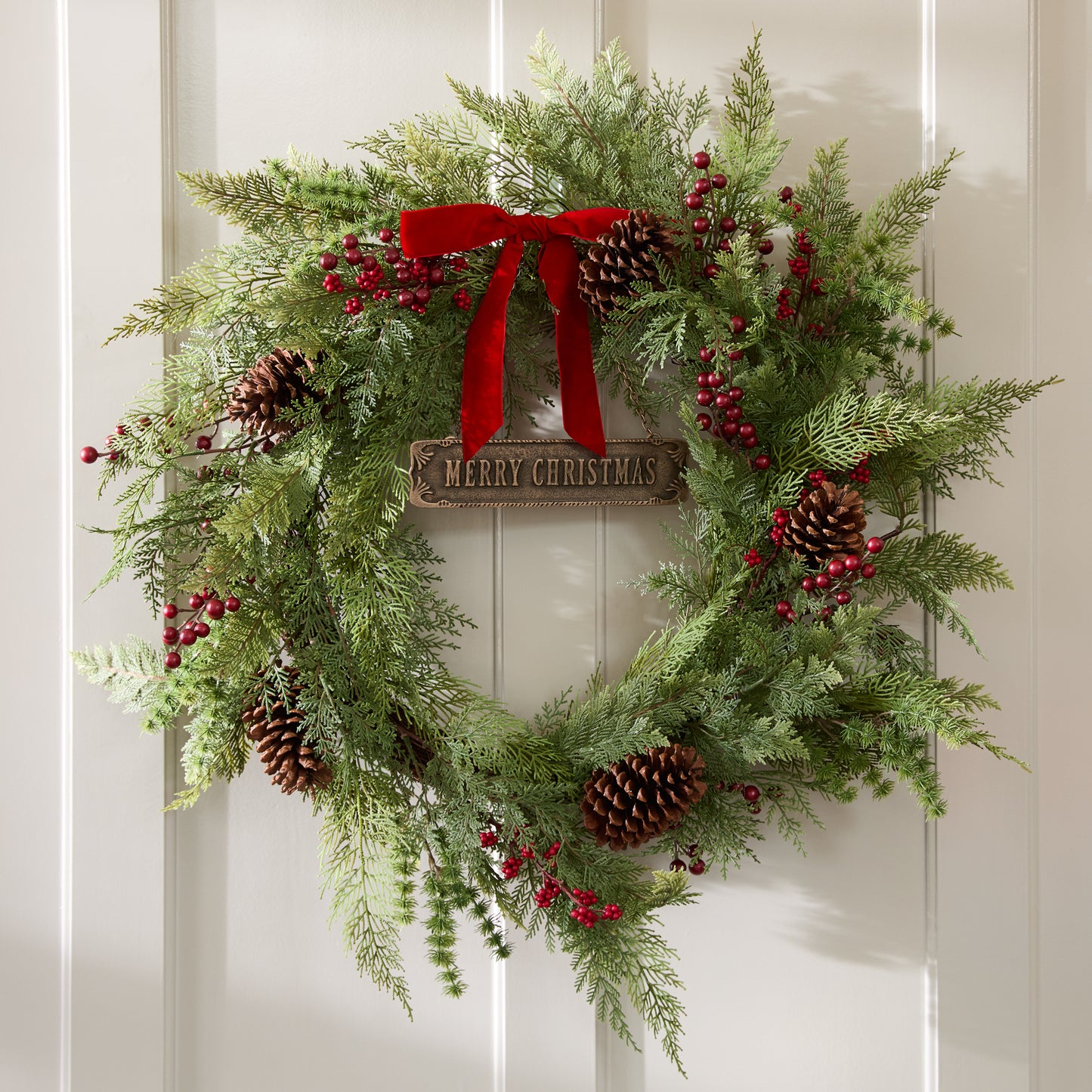 Real Touch Foraged Red Berry Pine Wreath on a wall