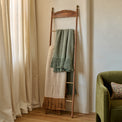 Gloria Carved Wood and Brass Decorative Ladder shown with blankets