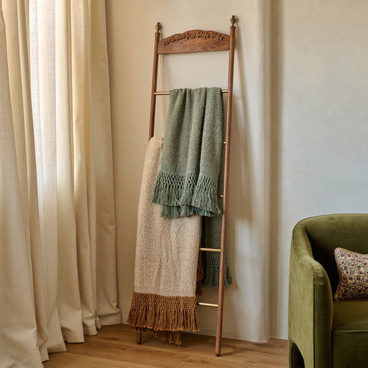 Gloria Carved Wood and Brass Decorative Ladder shown with blankets