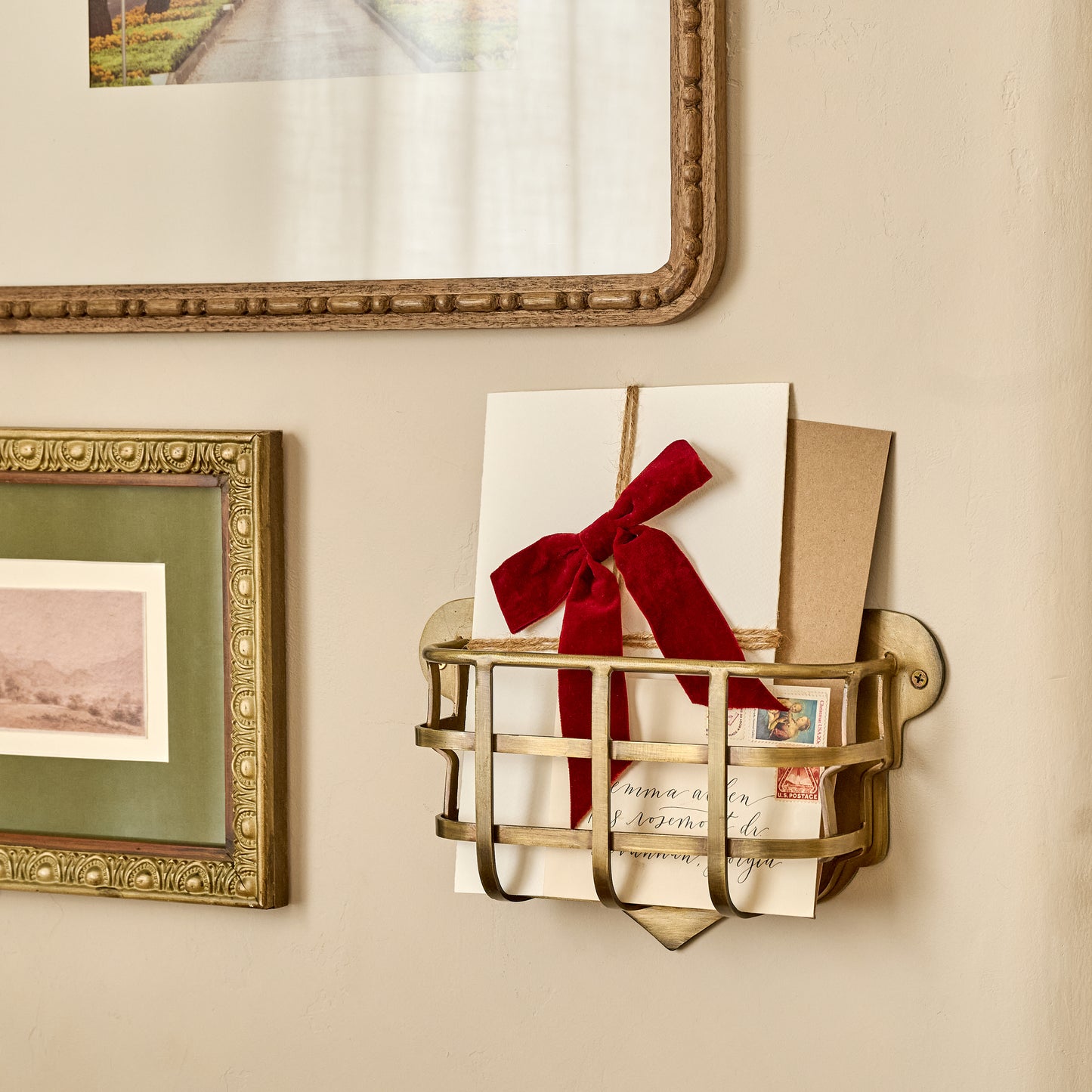Antiqued Brass Mail Holder shown holding mail on wall