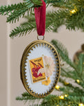 Eloise Photo Frame Ornament shown hung on tree with stamp and flower framed