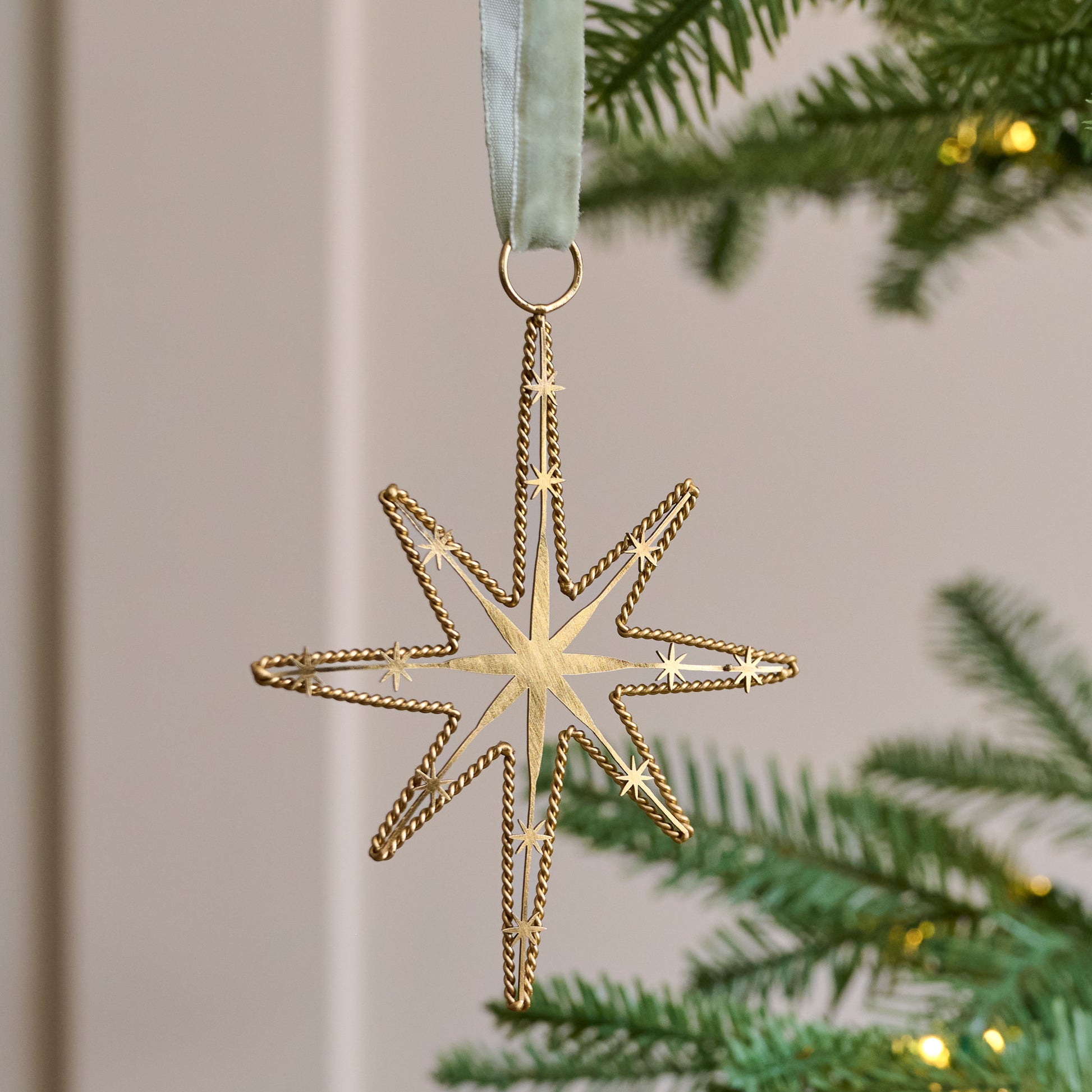 Twisted Brass Star Ornament shown on tree