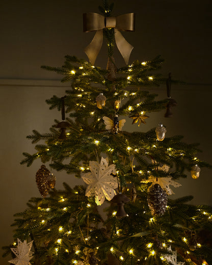 Clara Brass Bow Tree Topper on a tree