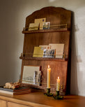 Gloria Carved Wood and Brass Display Shelf in a room