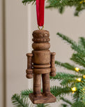 Wooden Nutcracker Ornament shown hung on christmas tree