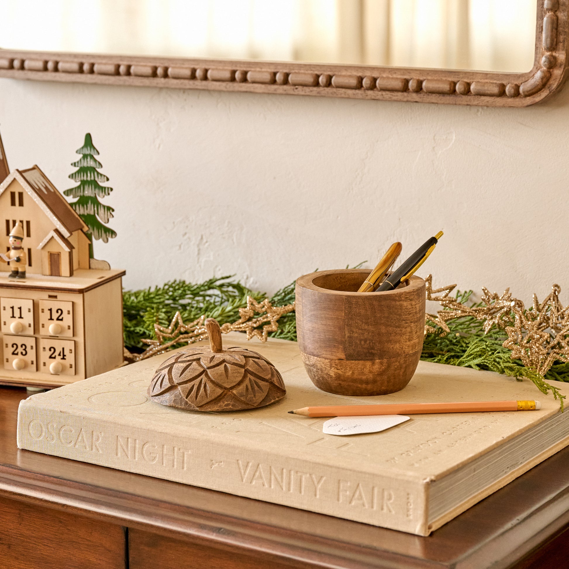 Hand-Carved Wooden Acorn Canister shown holding writing utensils