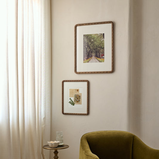 Nicolette Carved Wood Photo Frames hanging on beige wall