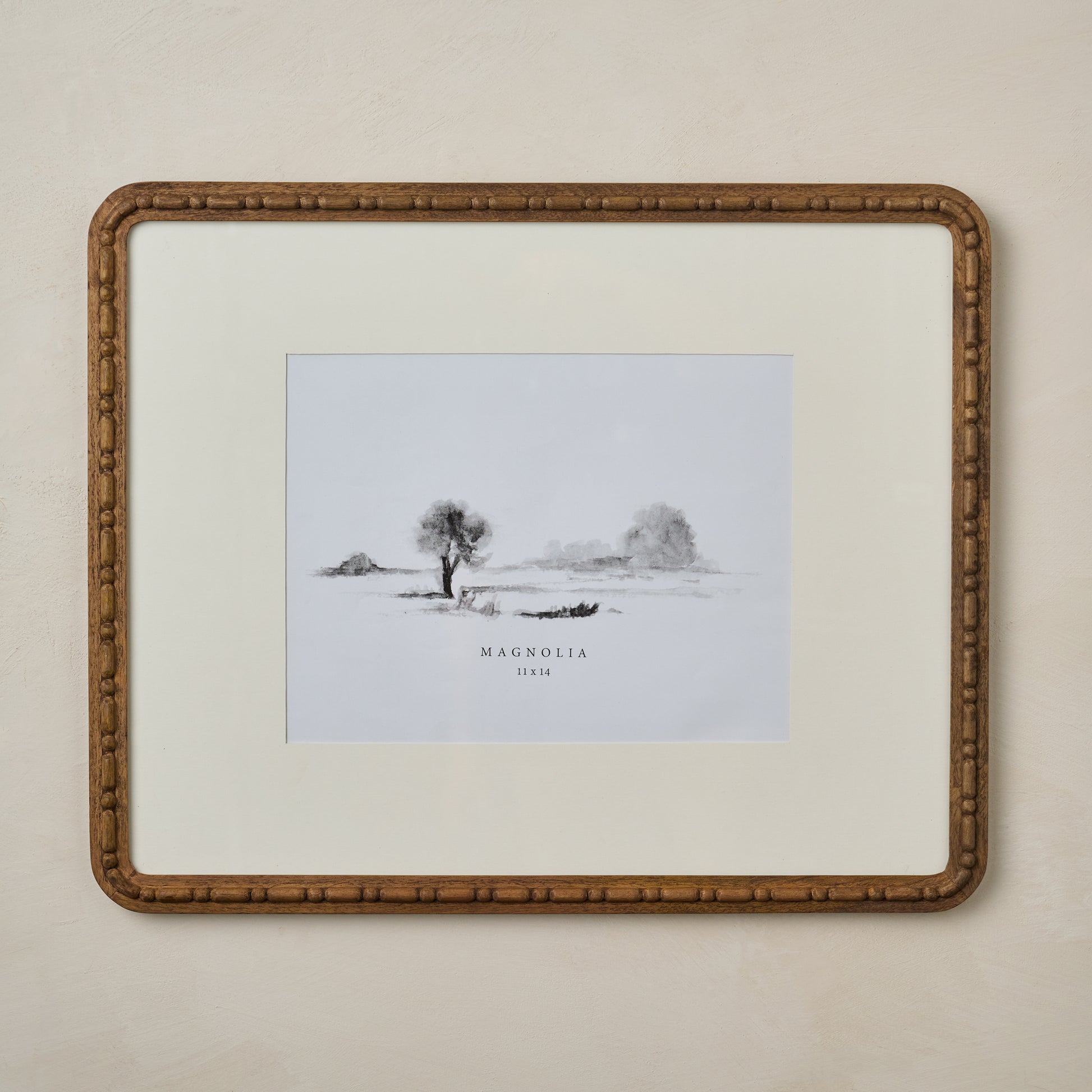 Nicolette Carved Wood Photo Frame in size 11x14 hanging on beige wall