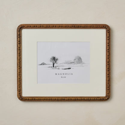 Nicolette Carved Wood Photo Frame in size 8x10 hanging on beige wall