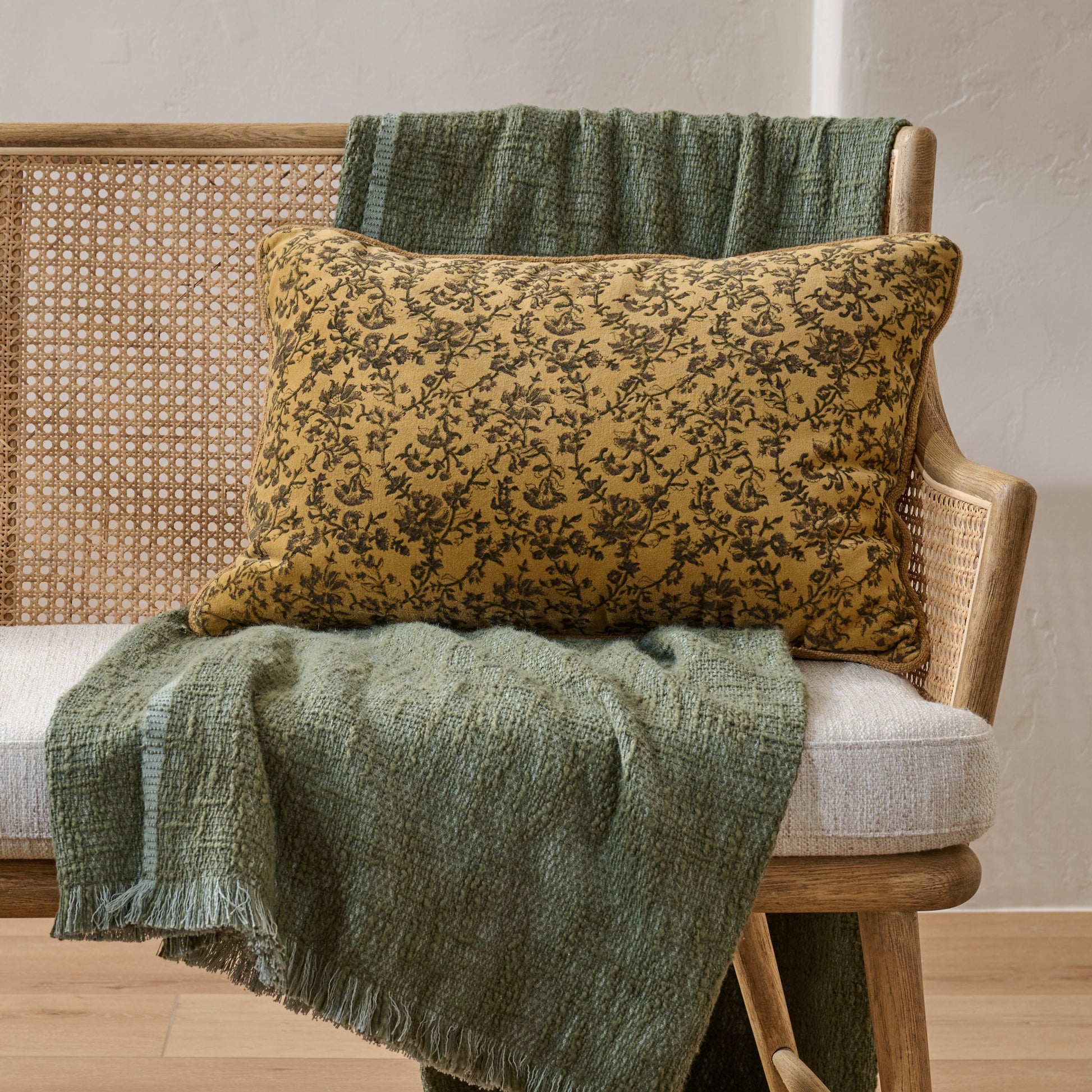 Velvet Amber Vines Lumbar Pillow shown on bench with blanket