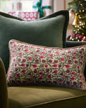 Festive Pomegranate Block Print Small Lumbar Pillow on a chair