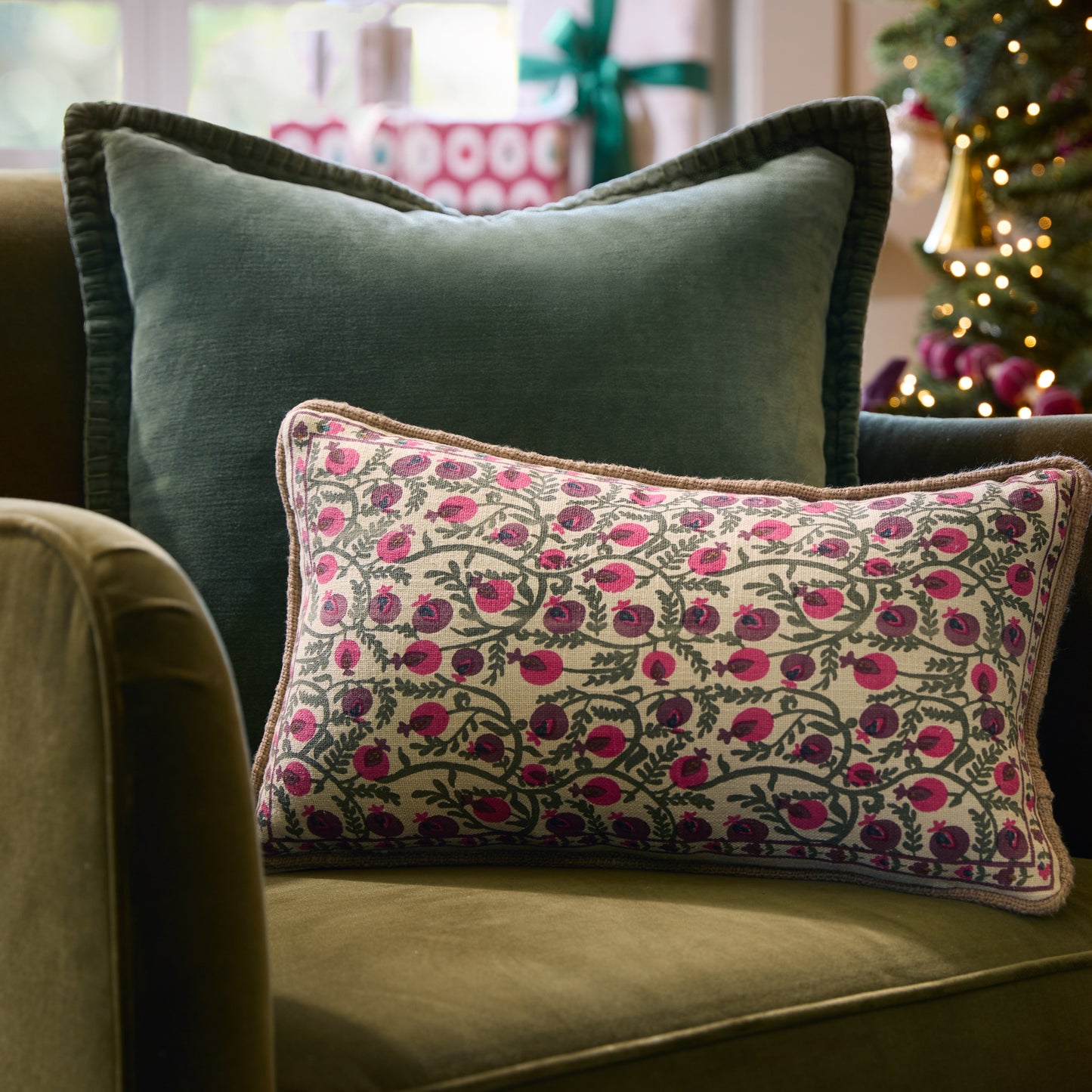 Festive Pomegranate Block Print Small Lumbar Pillow on a chair