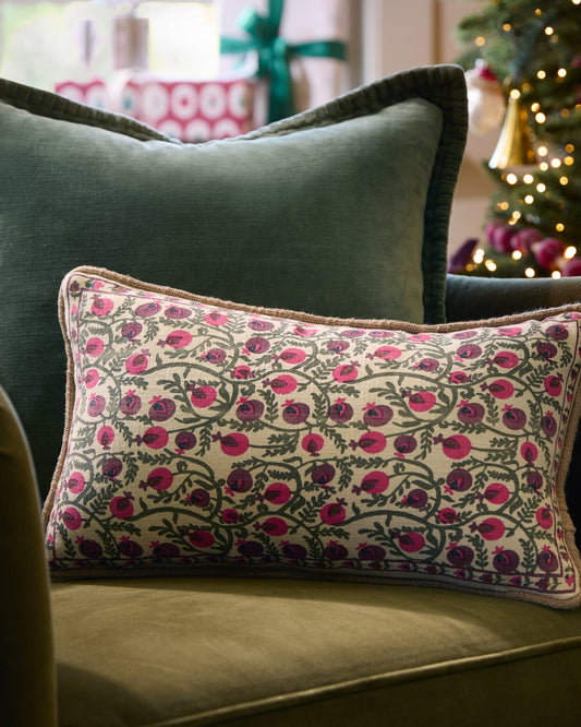 Festive Pomegranate Block Print Small Lumbar Pillow on a chair