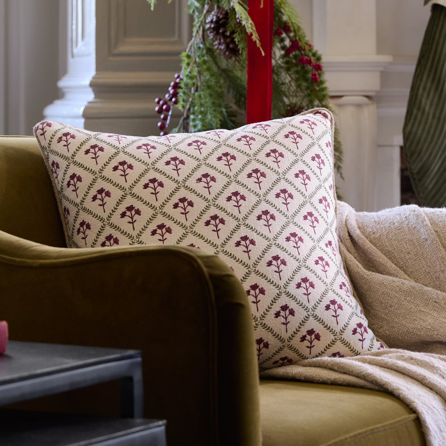 Magnolia Holiday Block Print Pillow shown on chair