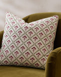 Magnolia Holiday Block Print Pillow shown on chair