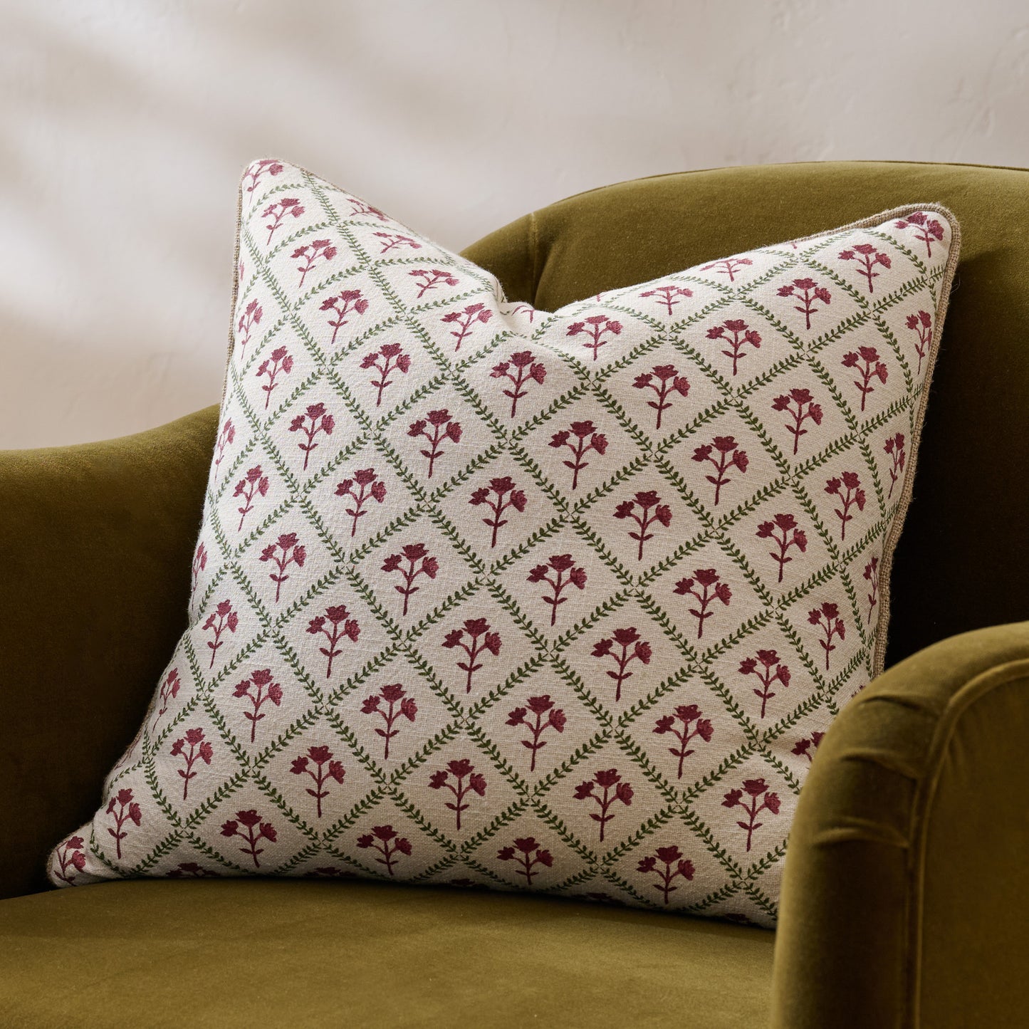 Magnolia Holiday Block Print Pillow shown on chair