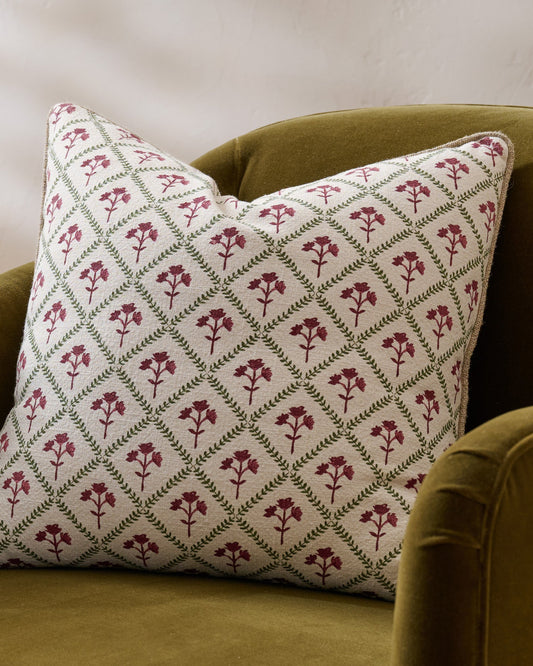 Magnolia Holiday Block Print Pillow shown on chair