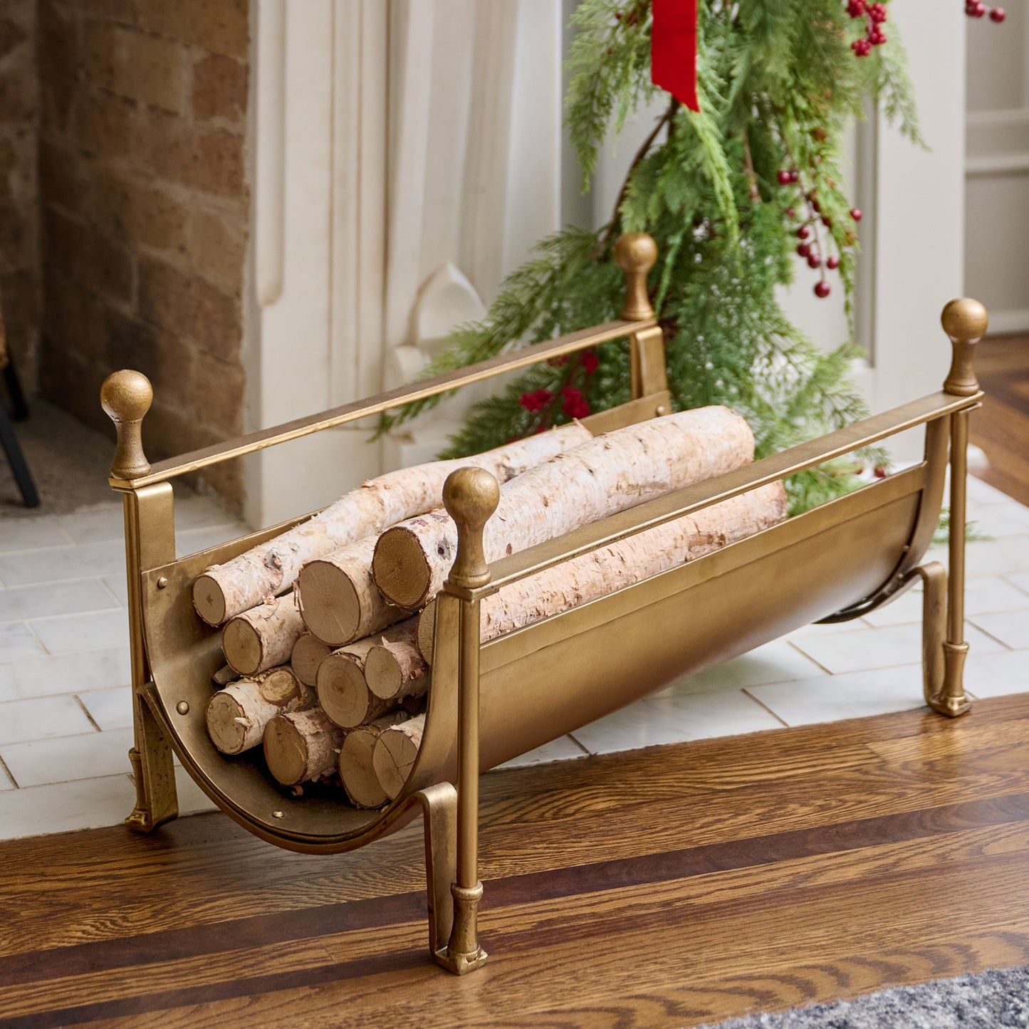 Shepherd Brass Log Holder shown holding logs