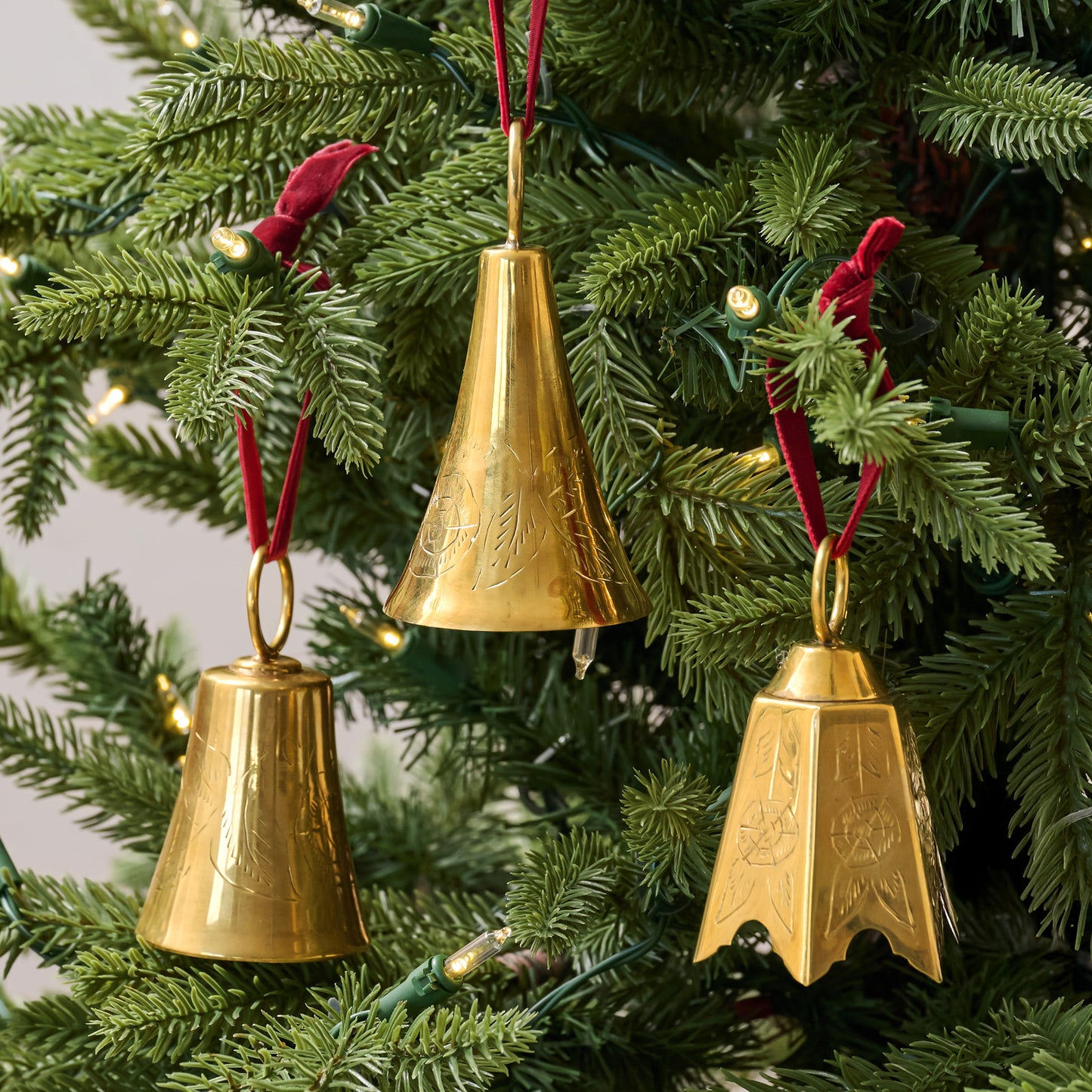 Ava Etched Brass Bell Ornament, Set of 3 hung on tree