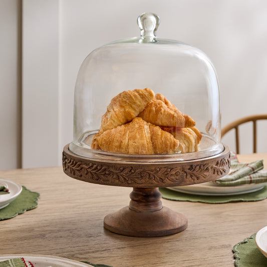 Eleanor Carved Wood Cake Stand with Glass Dome shown with croissants