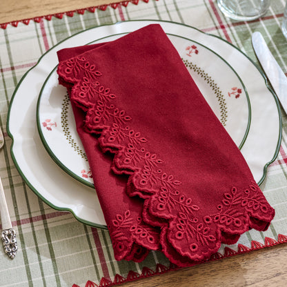 Syrah Embroidered Scalloped Edge Napkin shown folded and set on holiday place setting