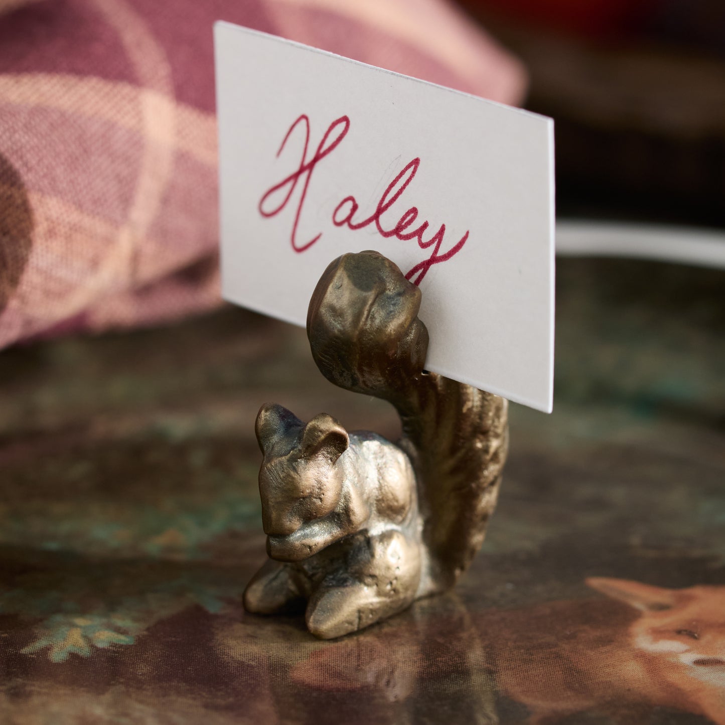 Antique Brass Squirrel Place Card Holder with a place card