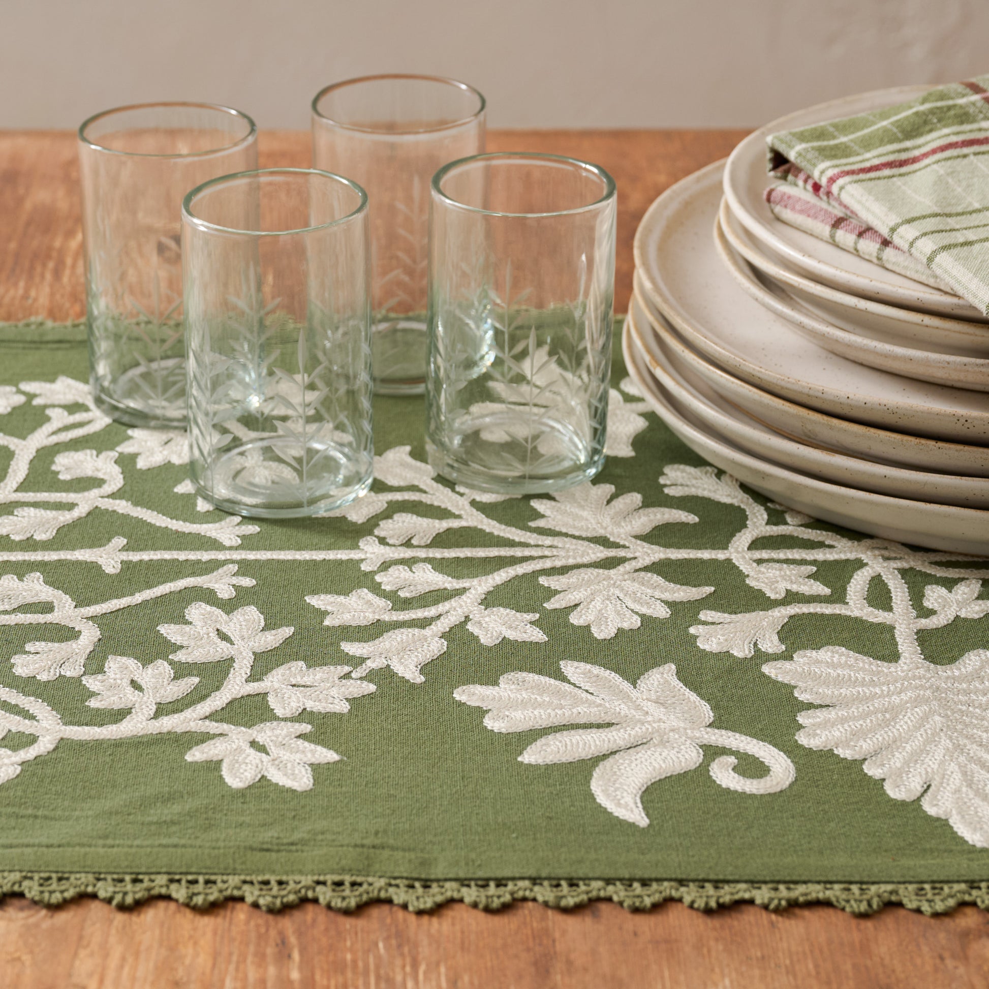 Winter Moss Embroidered Table Runner shown on table with etched glasses