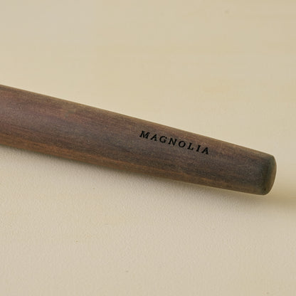 The Gristmill Collection Walnut Rolling Pin zoomed in with 'Magnolia' etched in