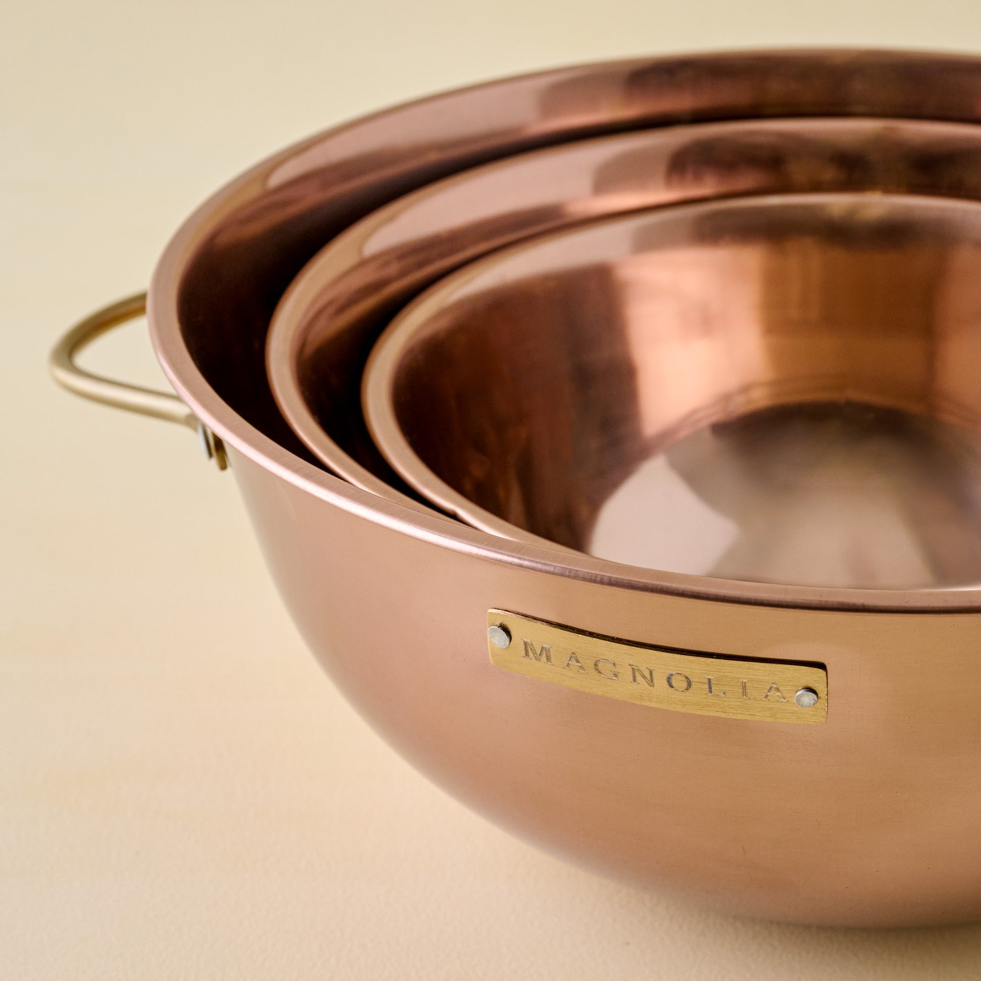 Magnolia Copper Mixing Bowl Set close up and stacked inside large mixing bowl