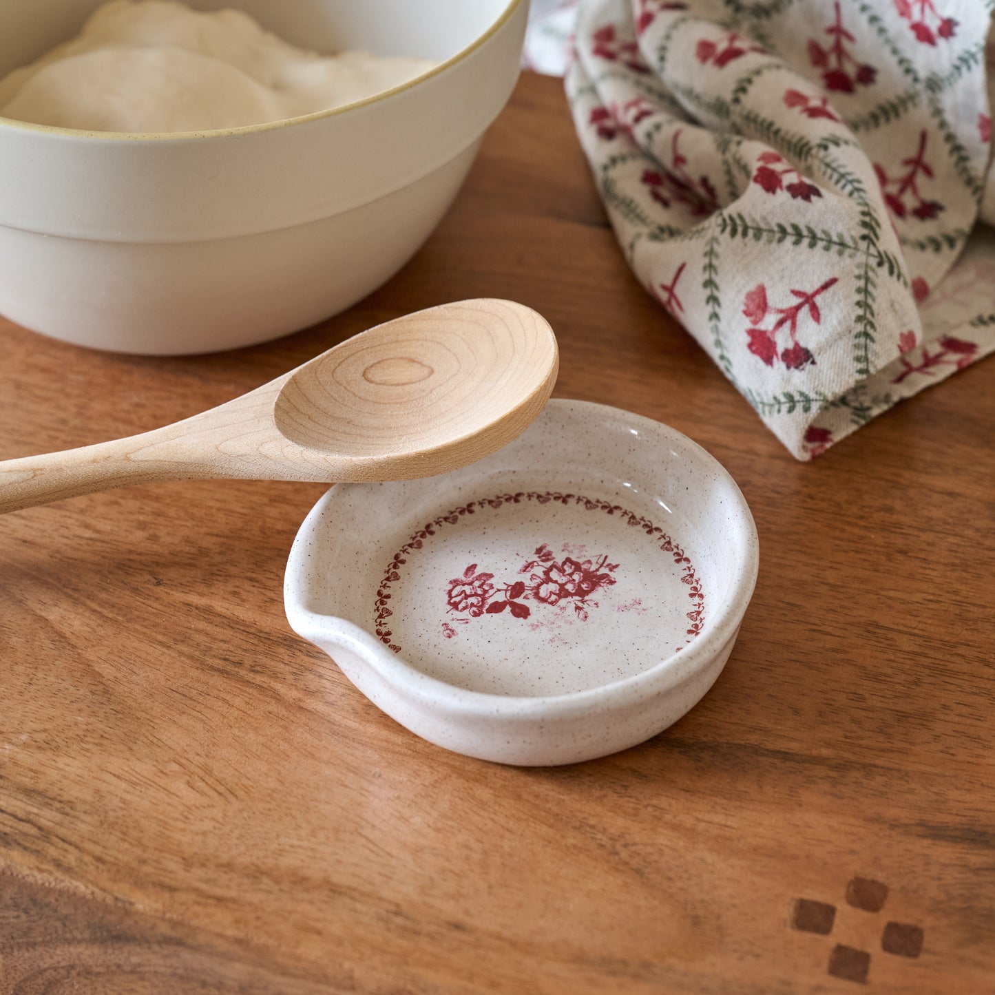 Heirloom Garden Scarlett Floral Spoon Rest shown with wooden spoon