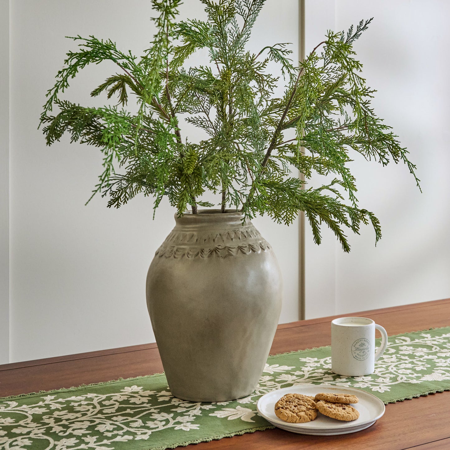 Evelyn Rustic Motif Vase shown on table holding seasonal stems
