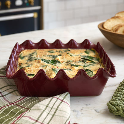 Syrah Scalloped 9x9 Baking Pan with lasagna in it