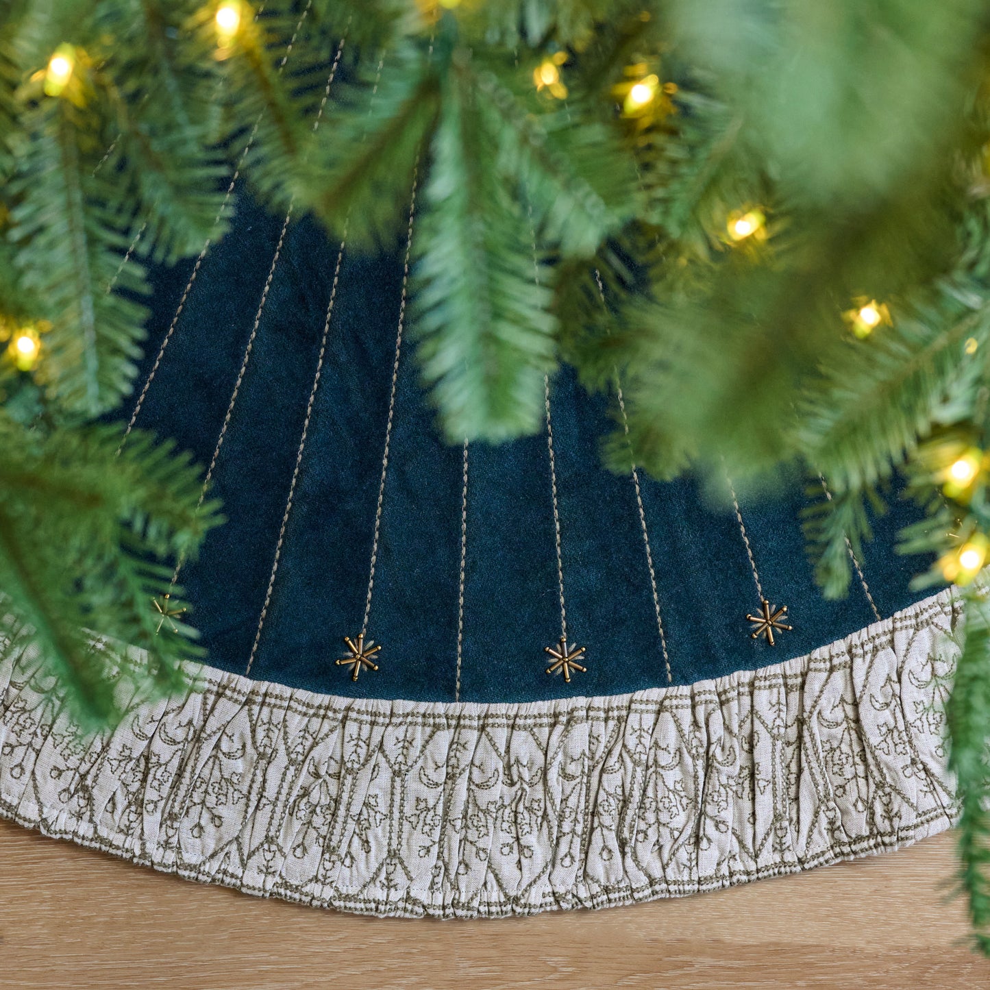 Hand-Beaded Evermore Velvet Tree Skirt shown from above under tree