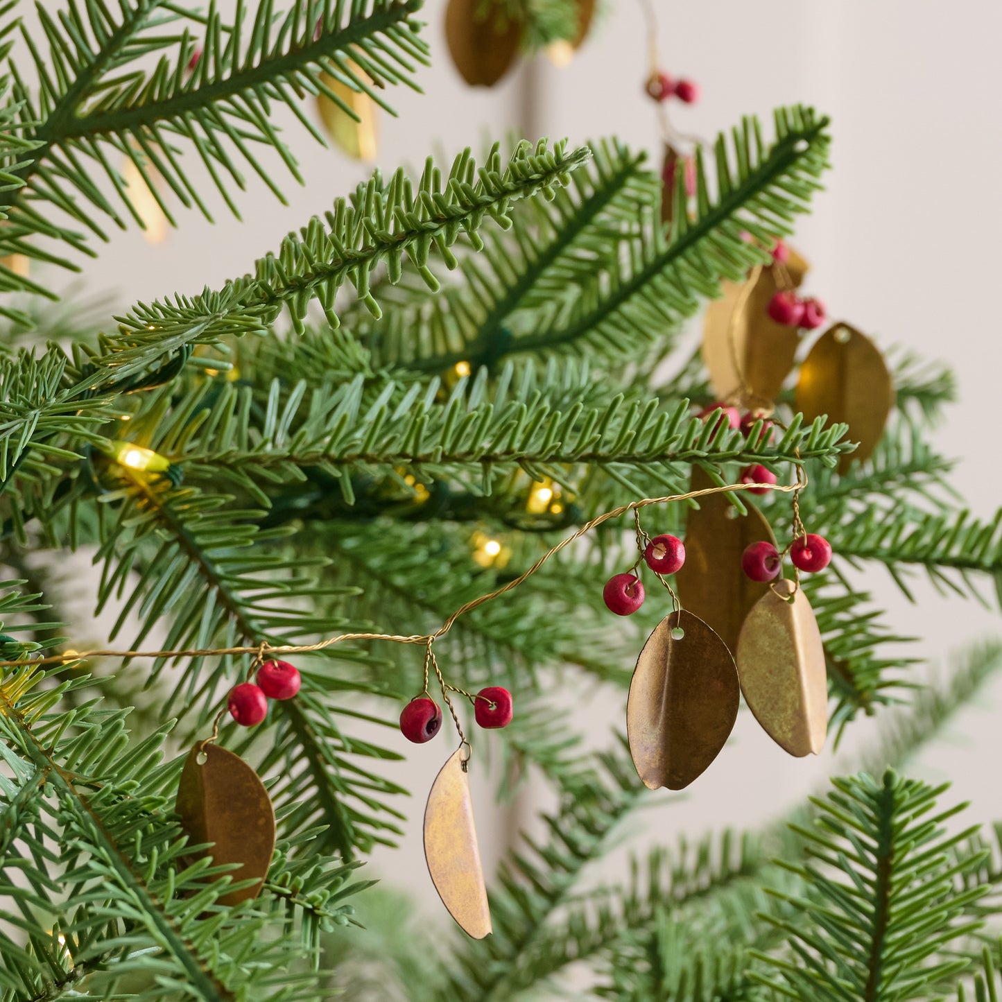Brass Leaf + Red Berry Garland shown on tree