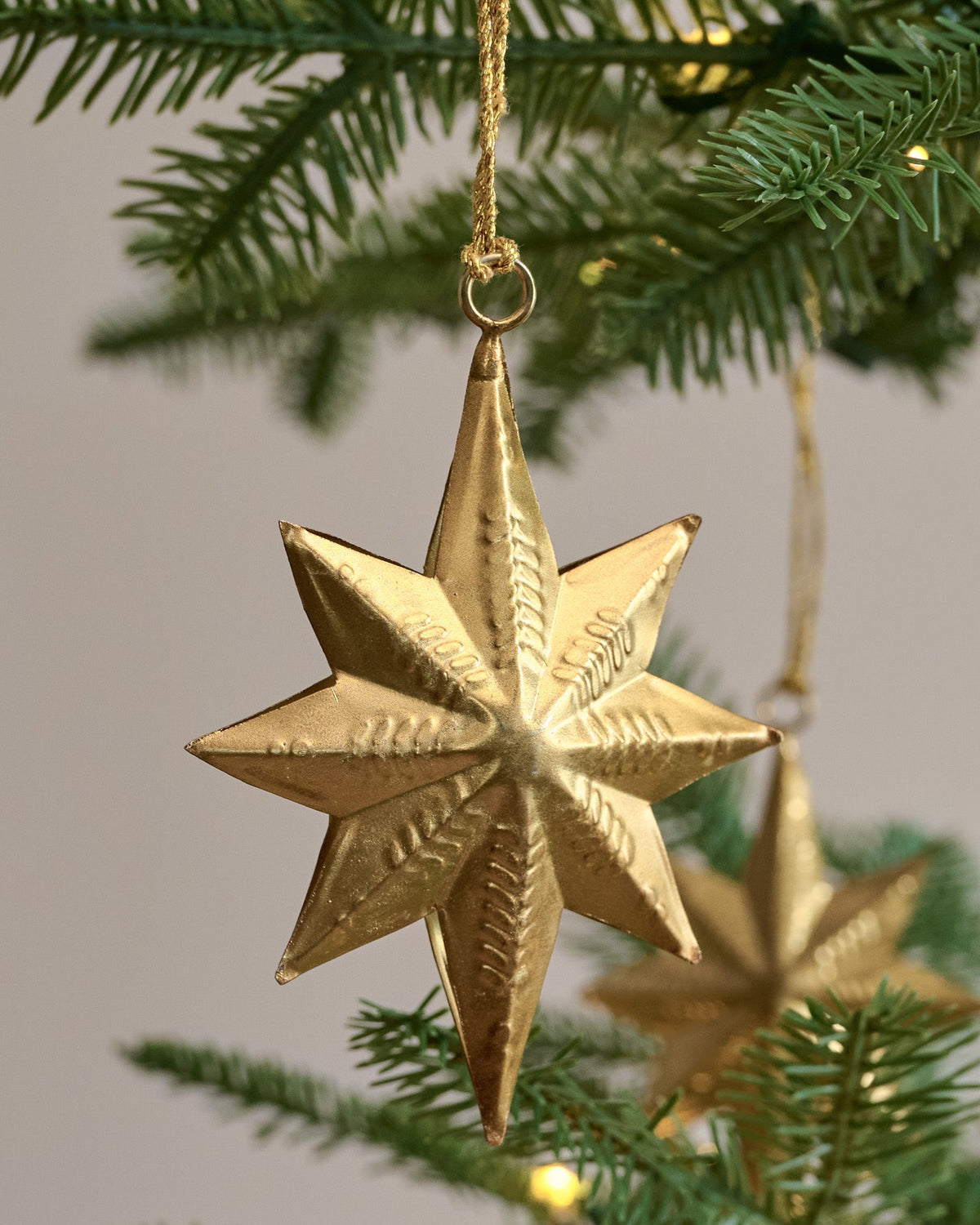 Celestial Star Ornaments, Set of 12 shown hung on tree