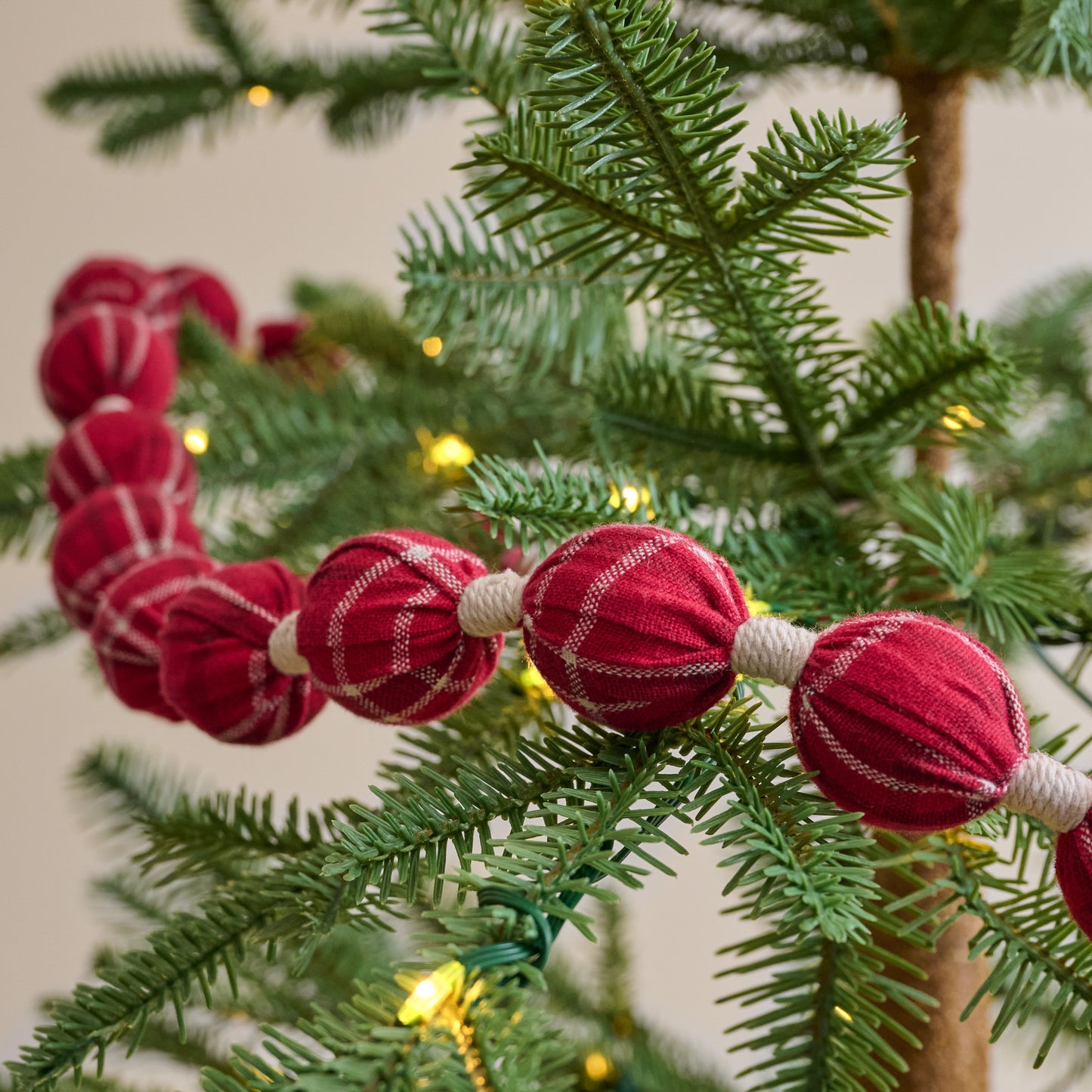 Home Again Plaid Garland up close shown on tree