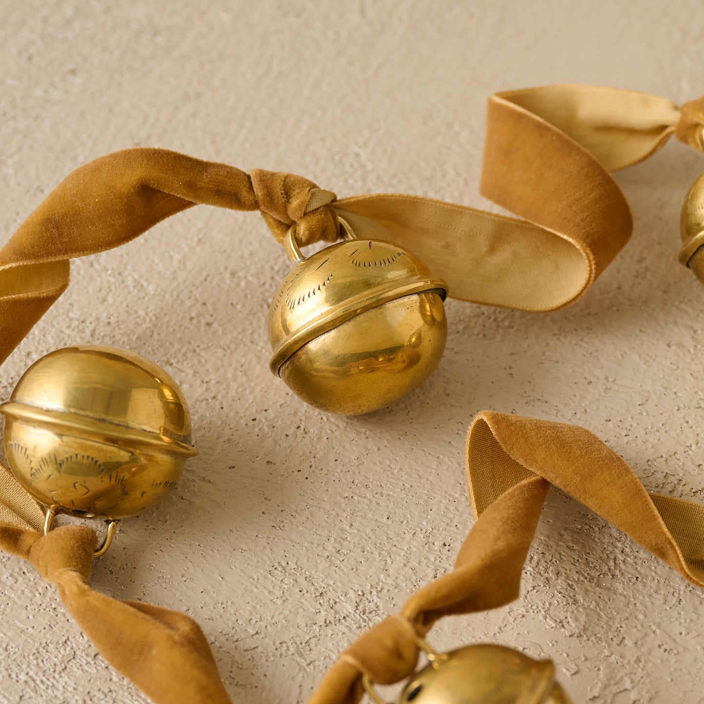 Etched Solid Brass Jingle Bell Garland up close