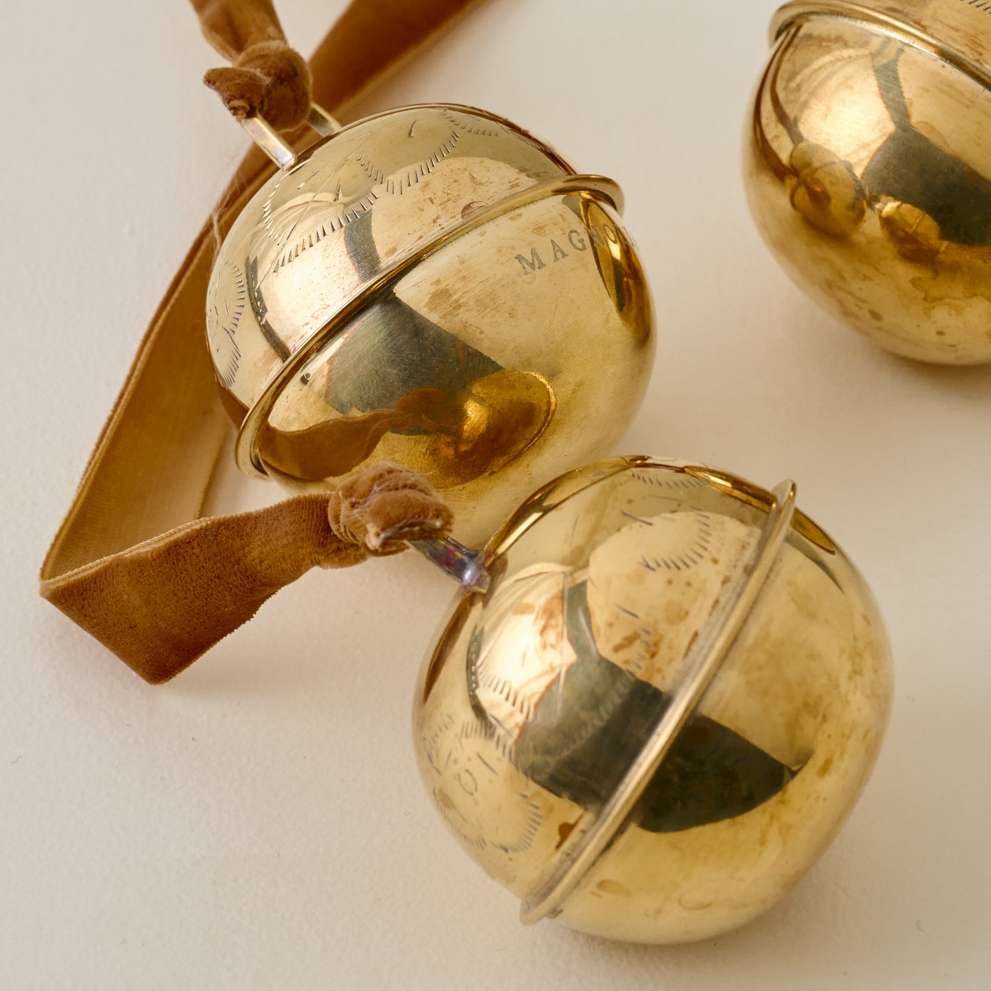Etched Solid Brass Jingle Bells up close