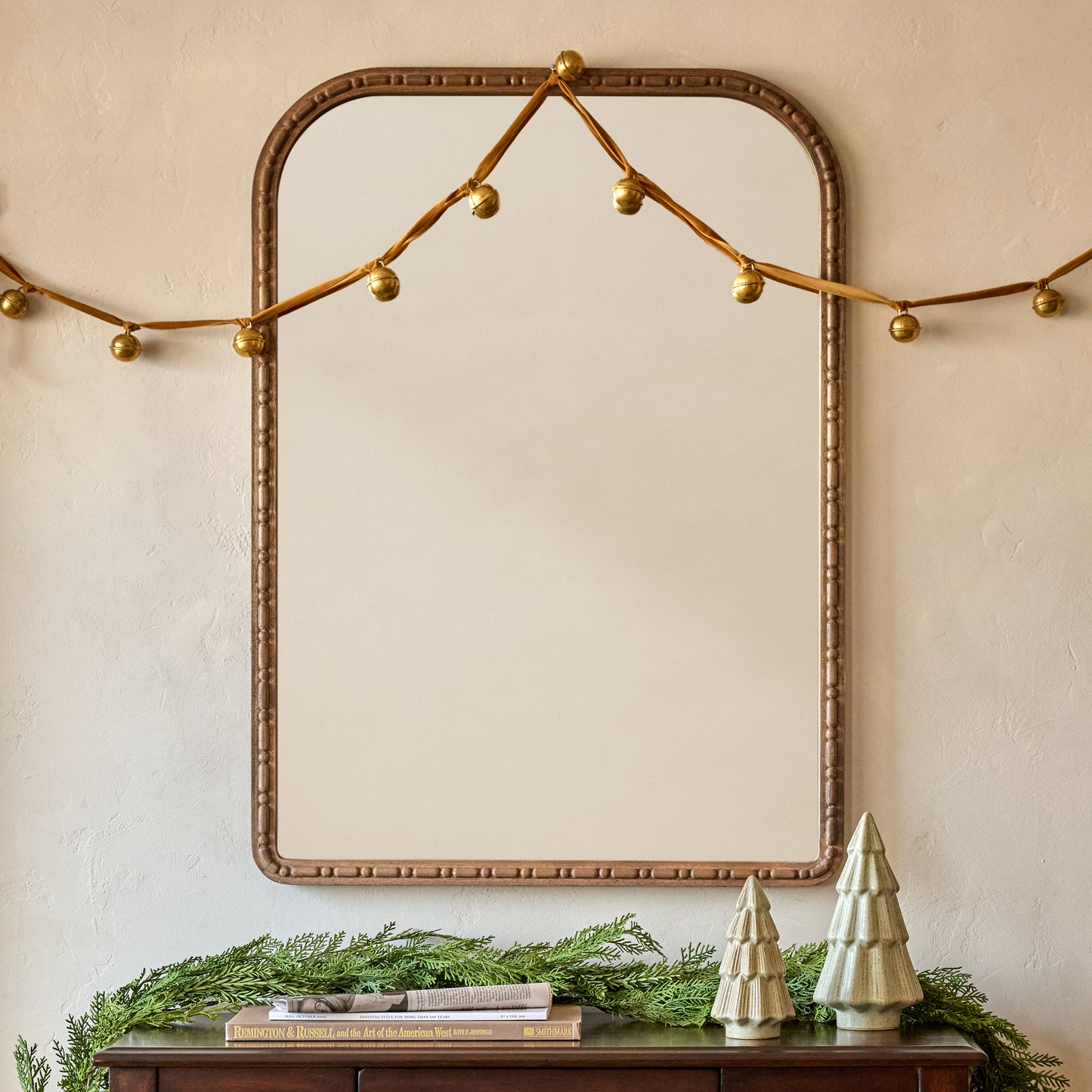 Etched Solid Brass Jingle Bells shown on mirror