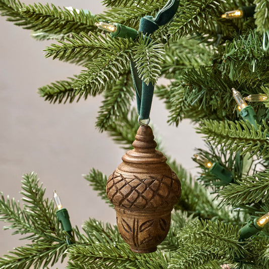 Hand Carved Wooden Acorn Ornament shown hung on tree