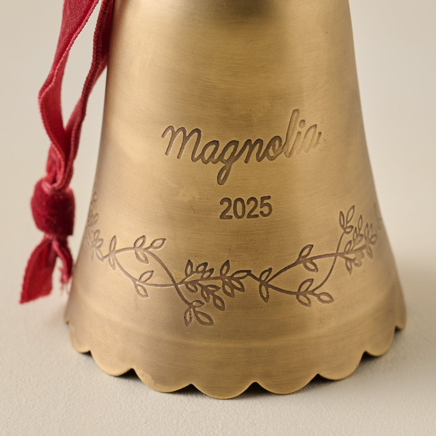 Engraved Magnolia Brass Bell Ornament up close